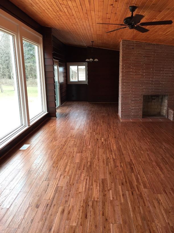 4985 Freeport Road Rockton, IL 61072 - Photo 6 of 24 a view of empty room with wooden floor and fireplace