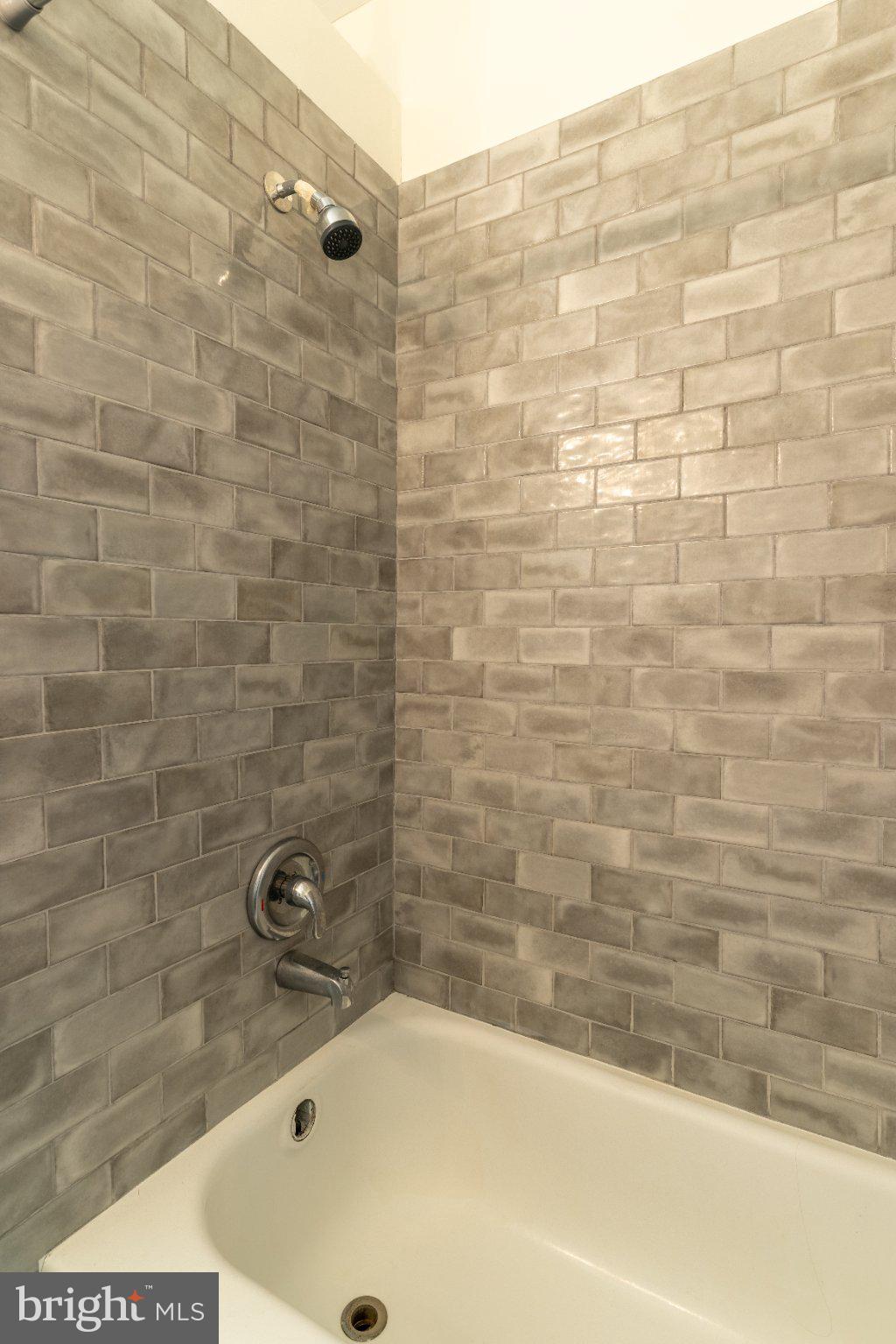 100 Potter Street, Unit 4 Haddonfield, NJ 08033 - Photo 8 of 18 Sleek gray tile shower retreat.