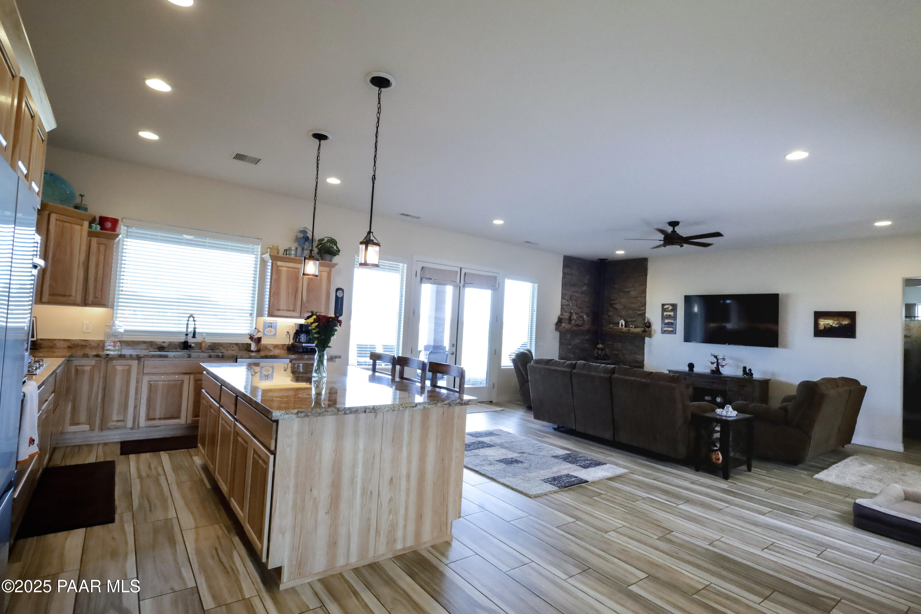 9860 North Loper Road Prescott Valley, AZ 86315 - Photo 28 of 53 a large living room with stainless steel appliances granite countertop couches a flat screen tv