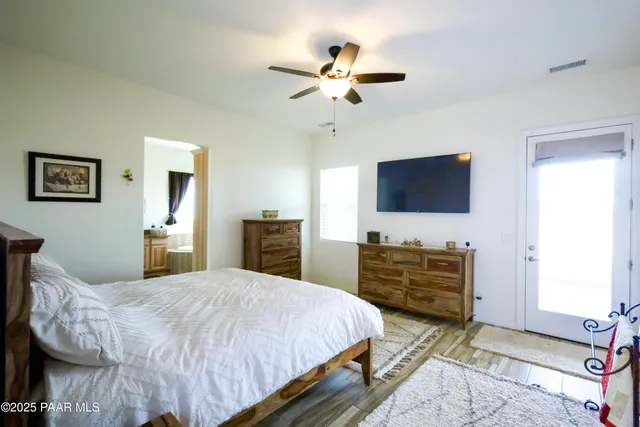 a bedroom with a bed and a dresser