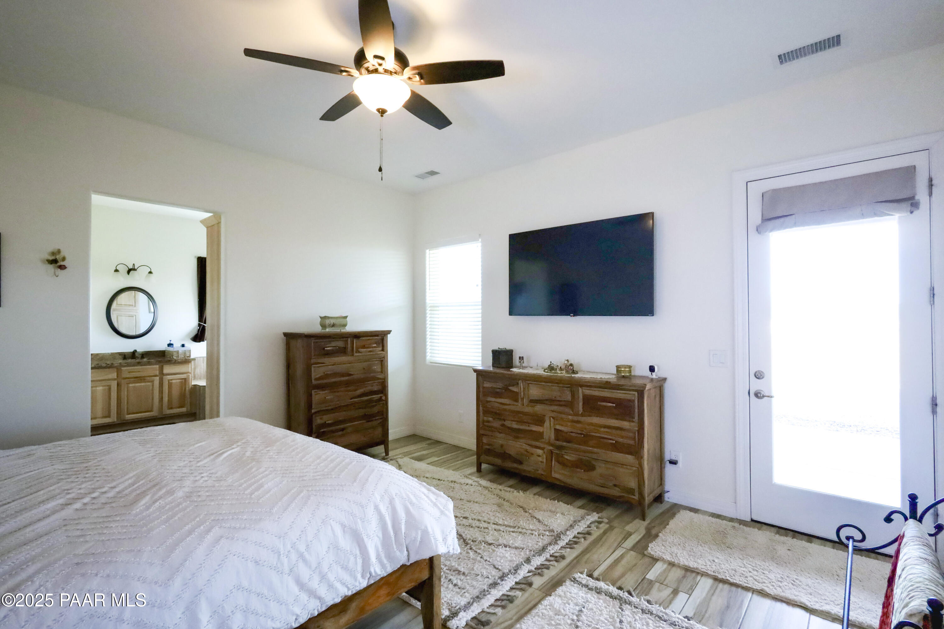 9860 North Loper Road Prescott Valley, AZ 86315 - Photo 34 of 53 a bedroom with a bed and a flat tv screen on dresser