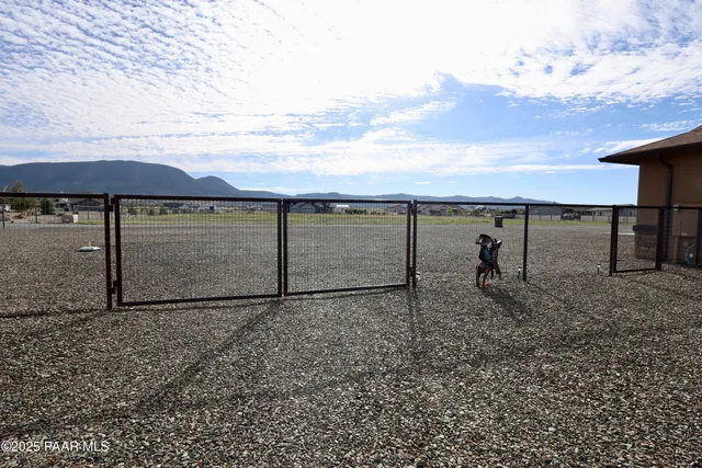 a view of a empty room with furniture and a ceiling fan