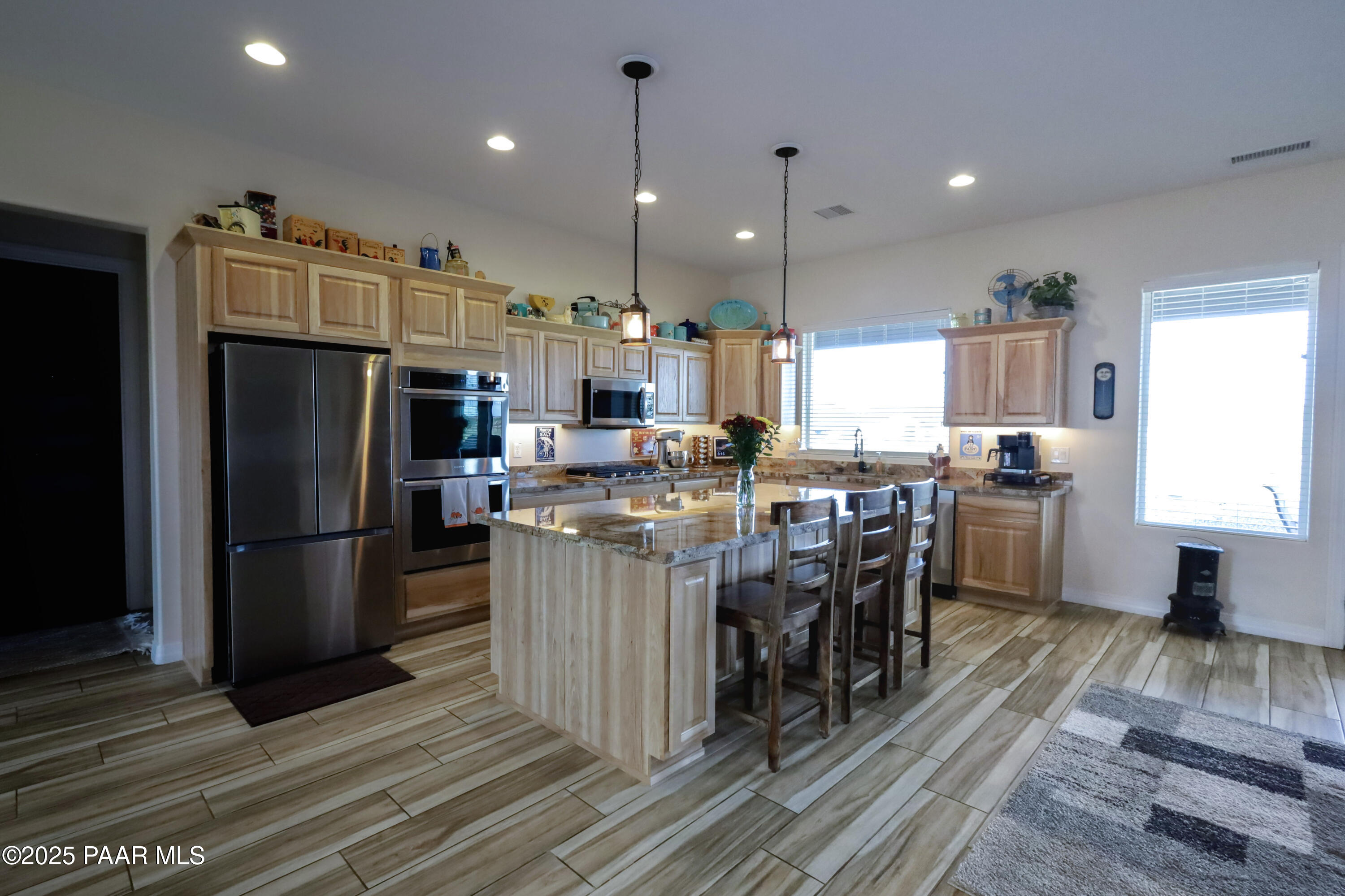 9860 North Loper Road Prescott Valley, AZ 86315 - Photo 10 of 53 a kitchen with stainless steel appliances granite countertop a refrigerator stove top oven and cabinets