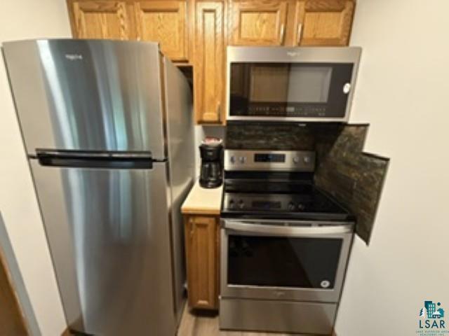 6266 Giants Ridge Road Biwabik, MN 55705 - Photo 24 of 30 Stainless steel appliance suite featuring a top-freezer refrigerator, electric range, and over-the-range microwave