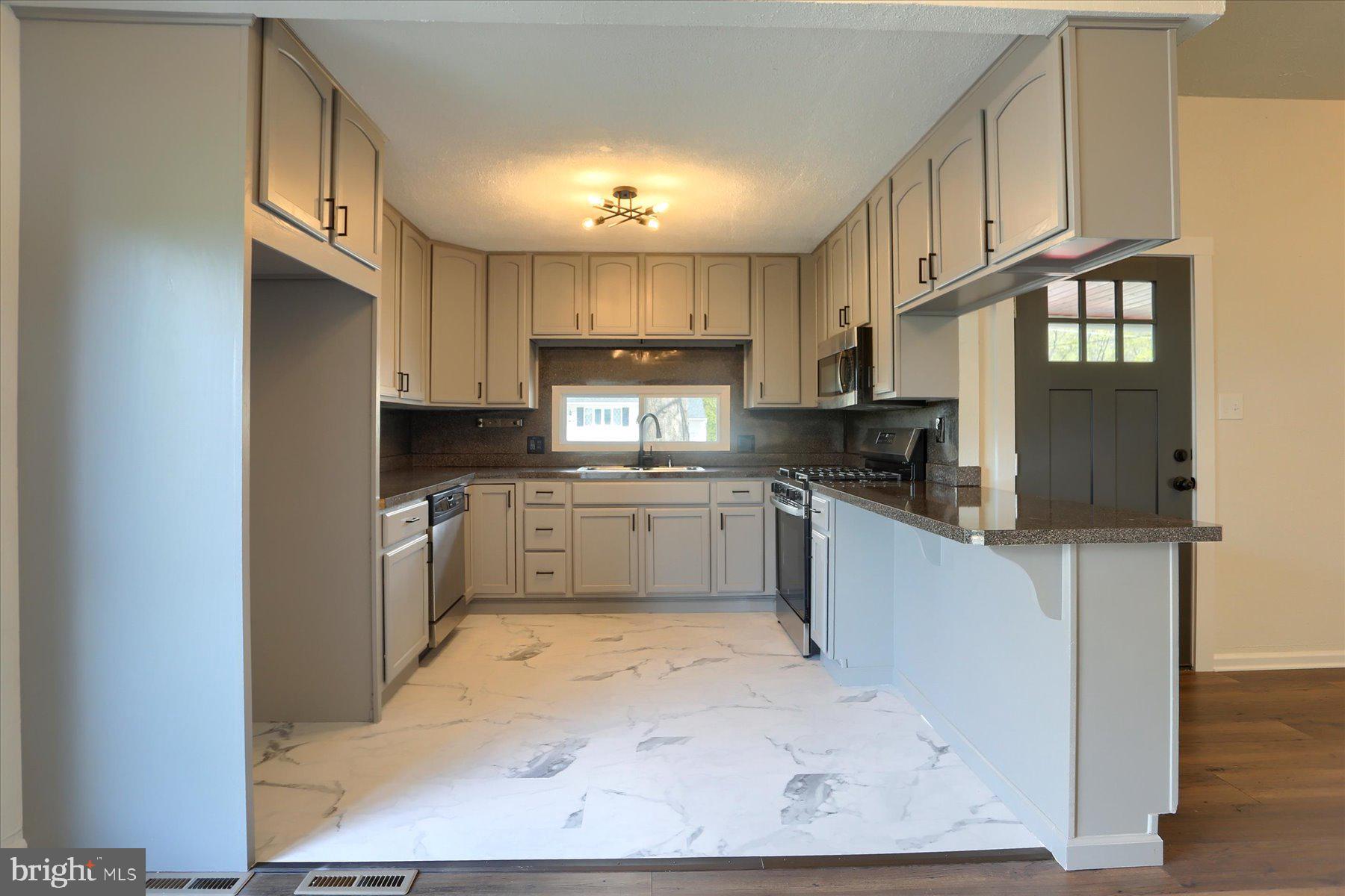 714 Edison Road Dauphin, PA 17018 - Photo 14 of 44 a kitchen with stainless steel appliances granite countertop a refrigerator sink and cabinets
