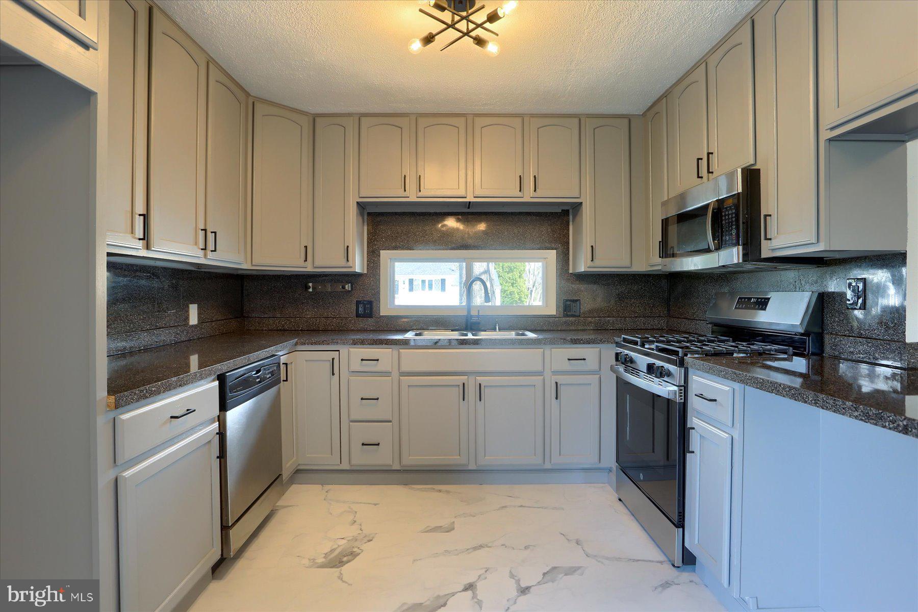 714 Edison Road Dauphin, PA 17018 - Photo 15 of 44 a kitchen with stainless steel appliances granite countertop a stove sink and cabinets