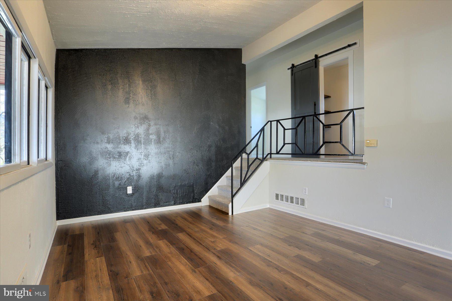 714 Edison Road Dauphin, PA 17018 - Photo 18 of 44 a view of a livingroom with wooden floor and a staircase