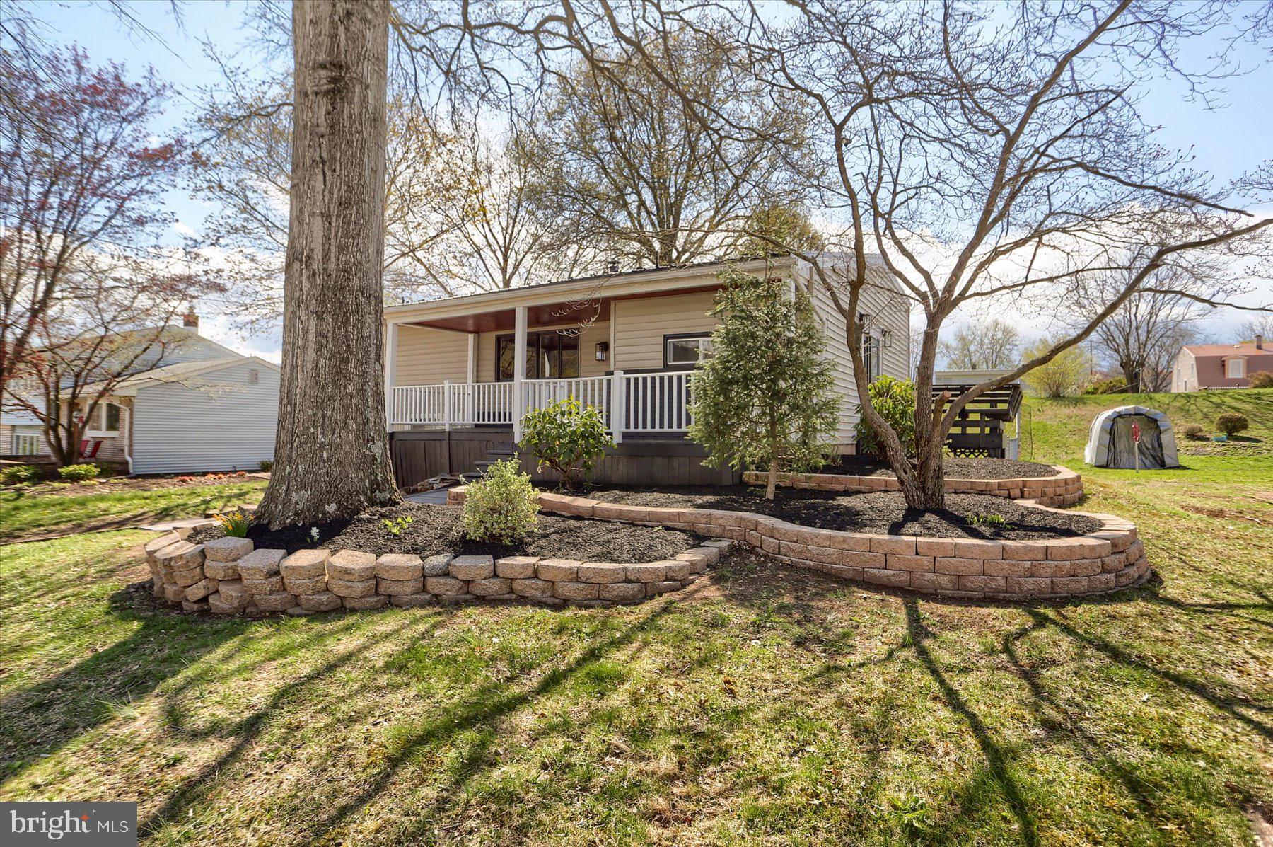 714 Edison Road Dauphin, PA 17018 - Photo 37 of 44 a front view of a house with garden and trees