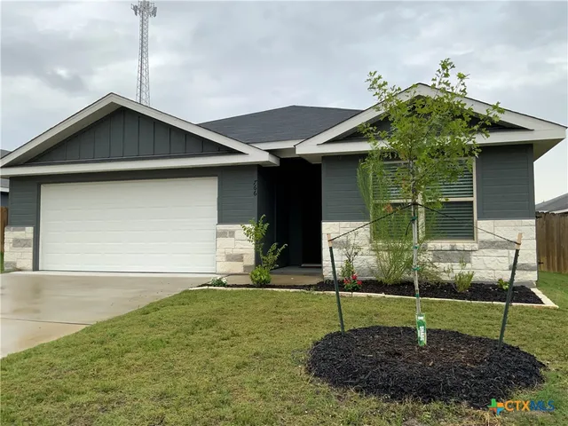 a house with sign broad in front of it
