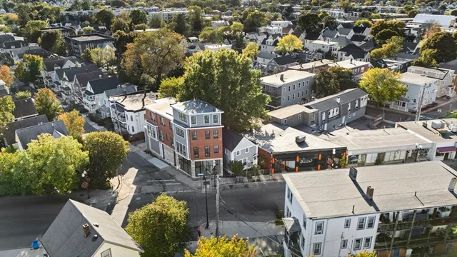 an aerial view of multiple houses with yard