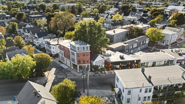 an aerial view of multiple houses with yard