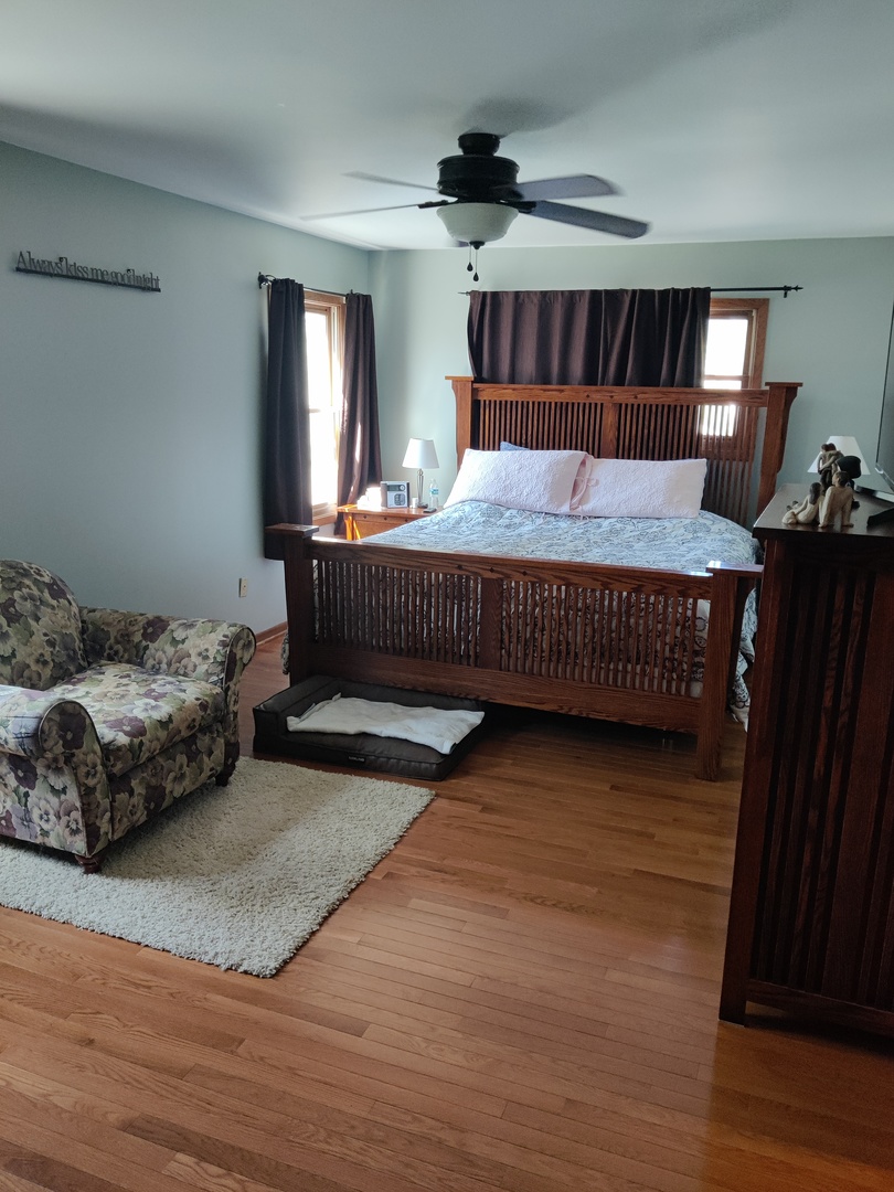 1681 Boulder Ridge Drive Bolingbrook, IL 60490 - Photo 14 of 17 a bedroom with a bed and wooden floor
