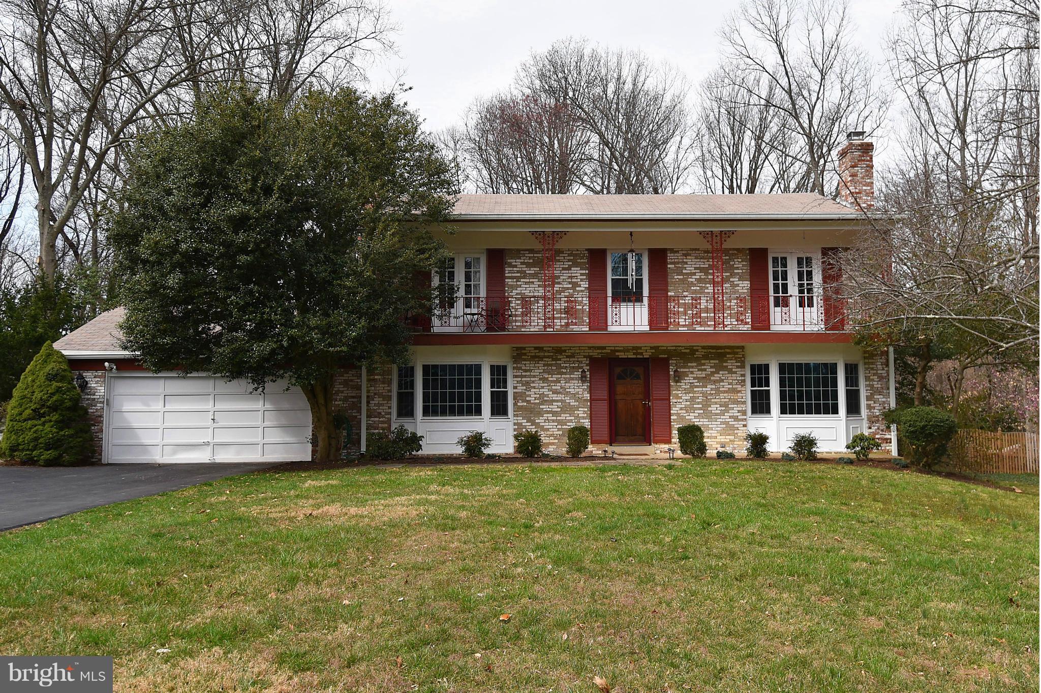 17939 Pond Road Ashton, MD 20861 - Photo 2 of 29 a front view of a house with a garden and trees