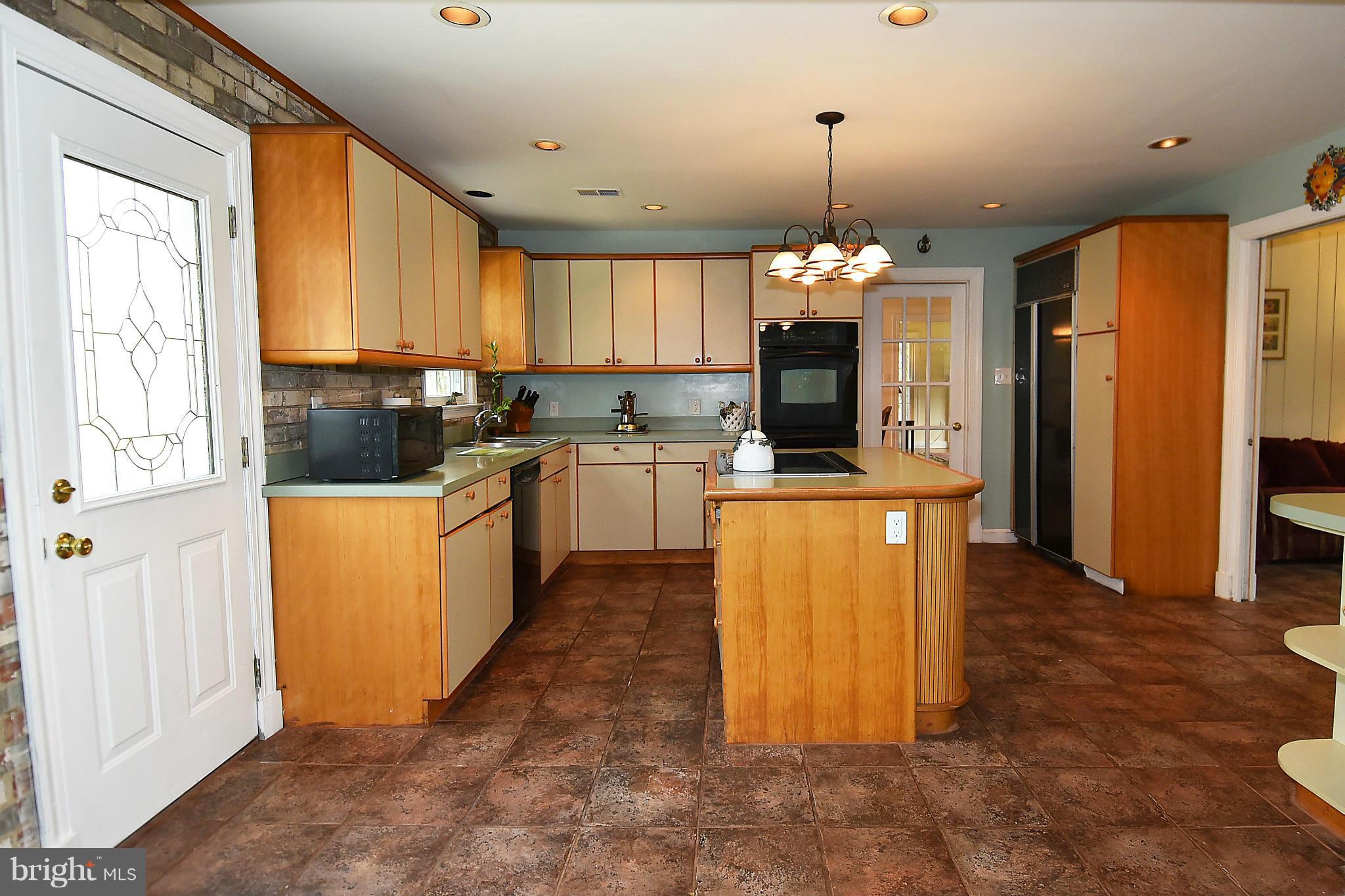 17939 Pond Road Ashton, MD 20861 - Photo 11 of 29 a kitchen with kitchen island granite countertop a stove a sink dishwasher and a refrigerator