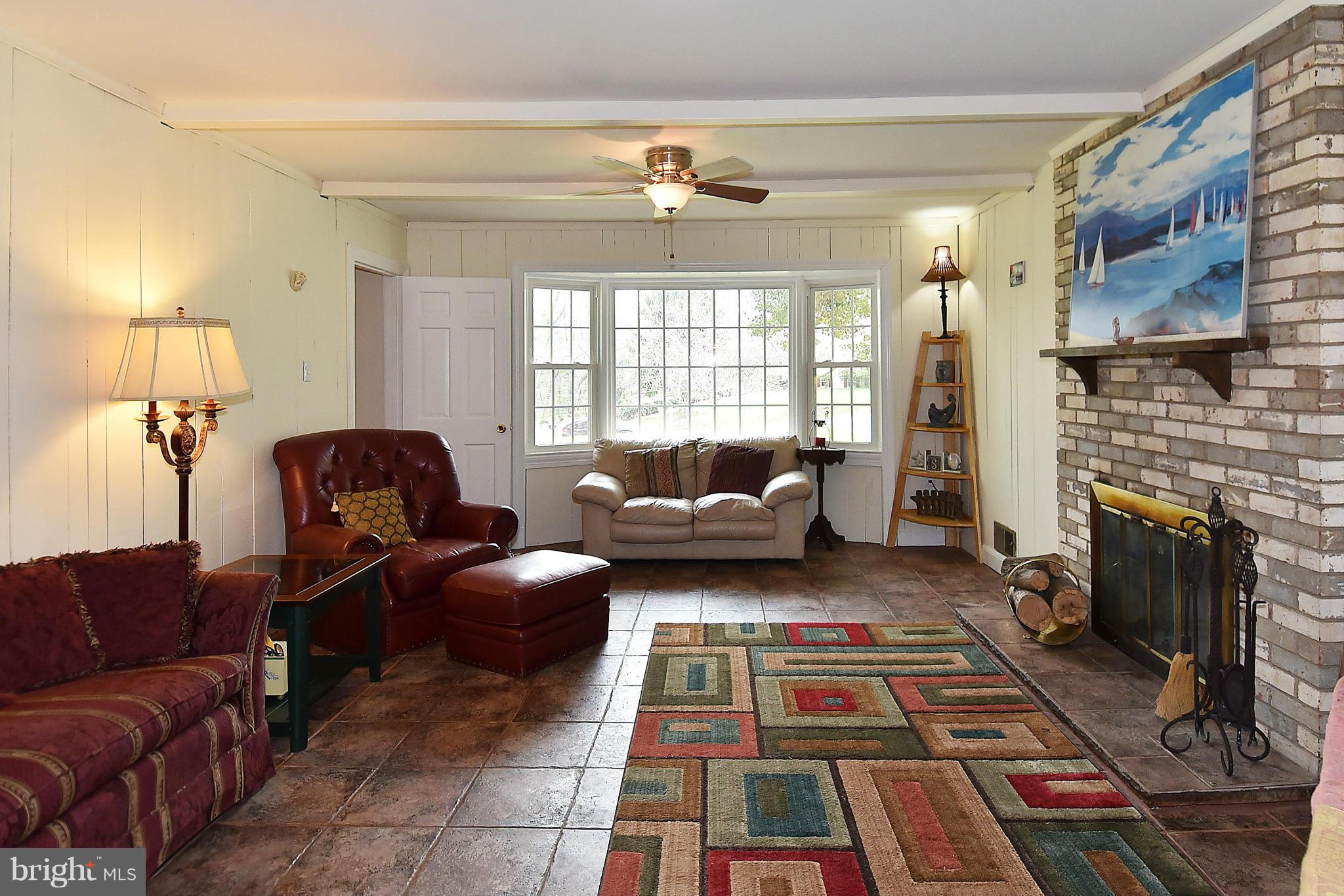 17939 Pond Road Ashton, MD 20861 - Photo 13 of 29 a living room with furniture and a fireplace