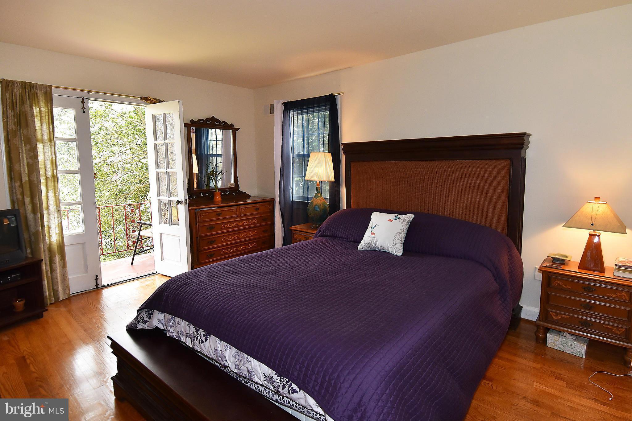 17939 Pond Road Ashton, MD 20861 - Photo 16 of 29 a bedroom with a bed and wooden floor