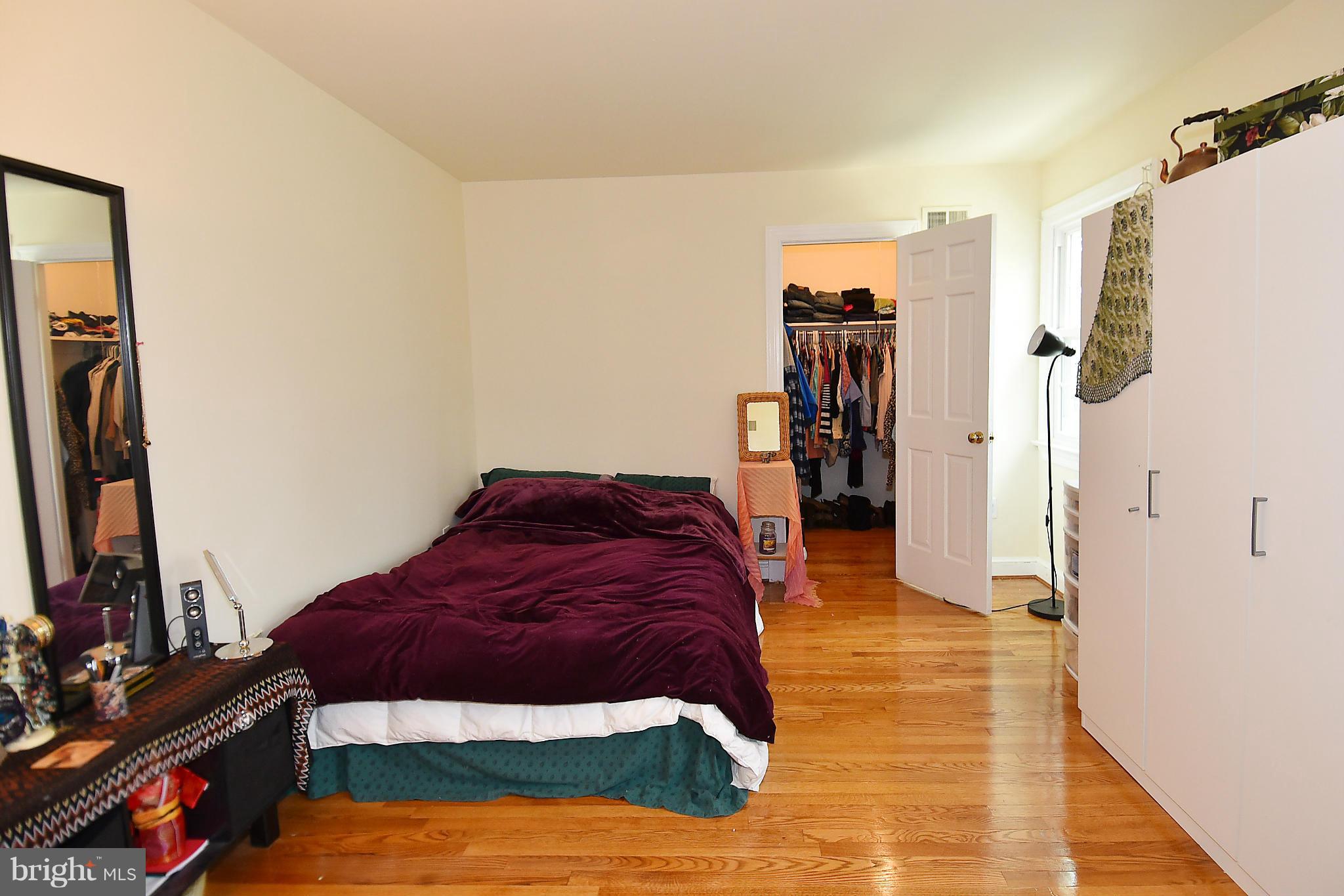 17939 Pond Road Ashton, MD 20861 - Photo 18 of 29 a spacious bedroom with a bed and a mirror