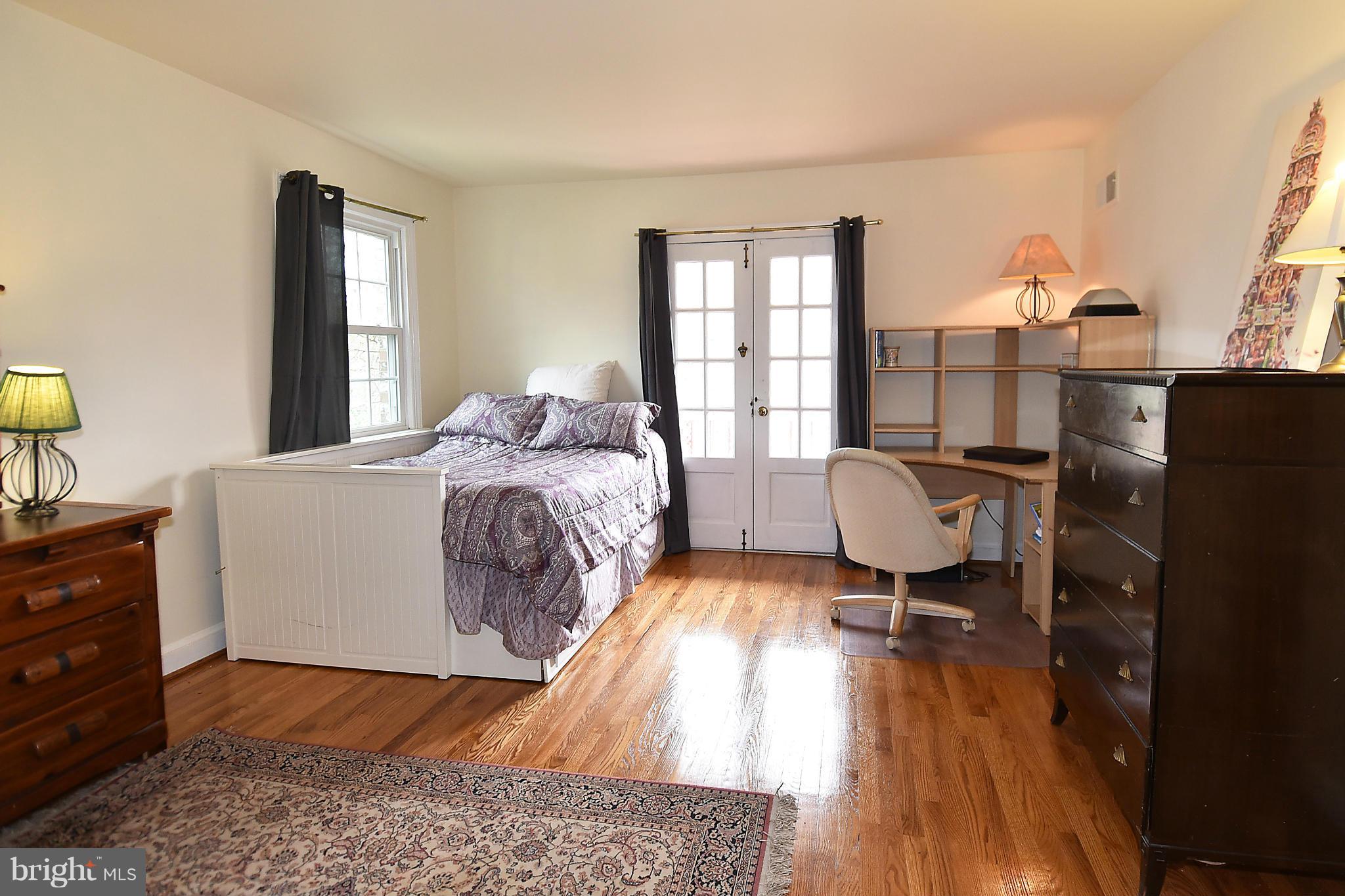 17939 Pond Road Ashton, MD 20861 - Photo 19 of 29 a bed room with a bed and a chair