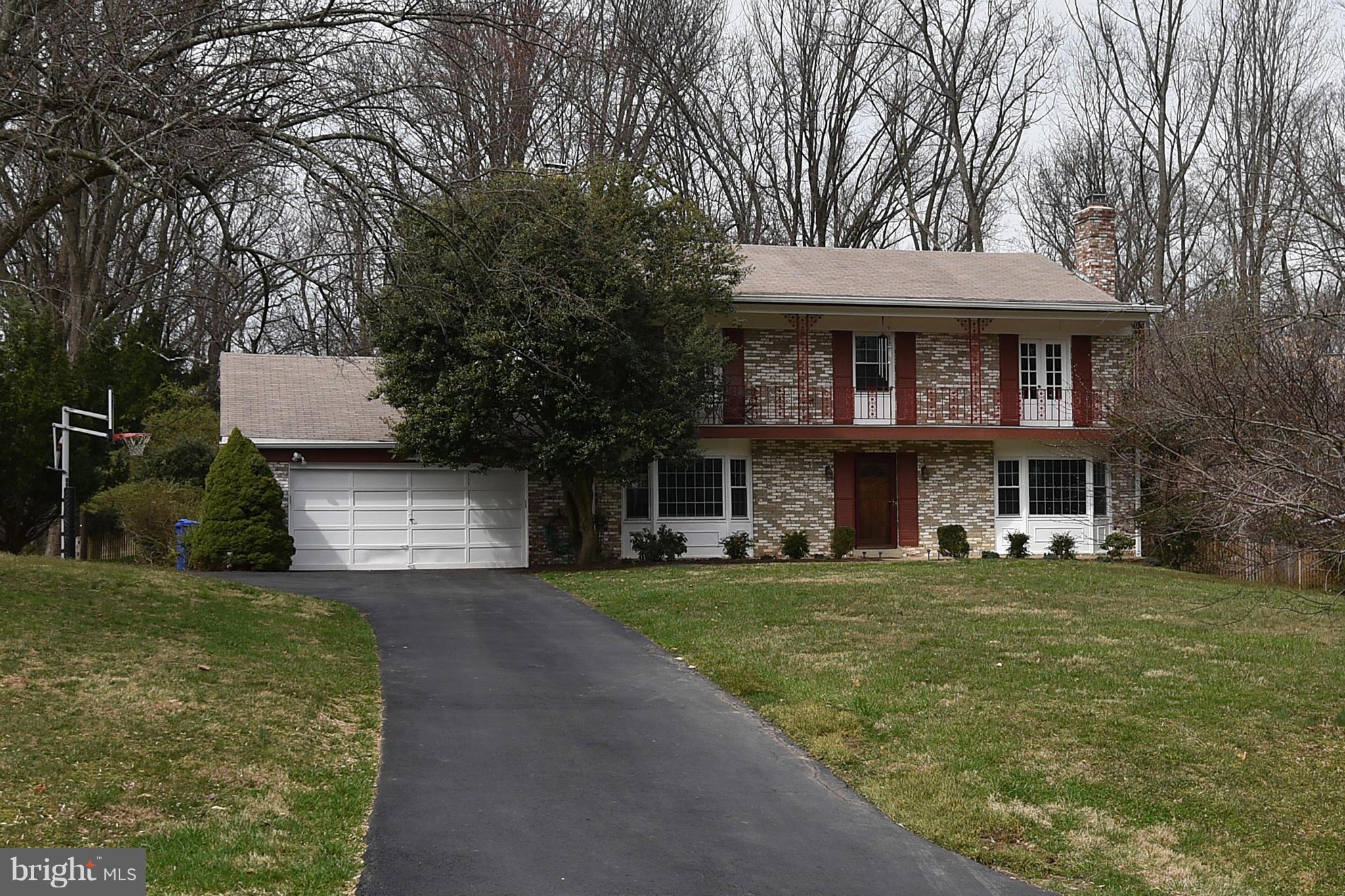 17939 Pond Road Ashton, MD 20861 - Photo 3 of 29 a front view of a house with a garden
