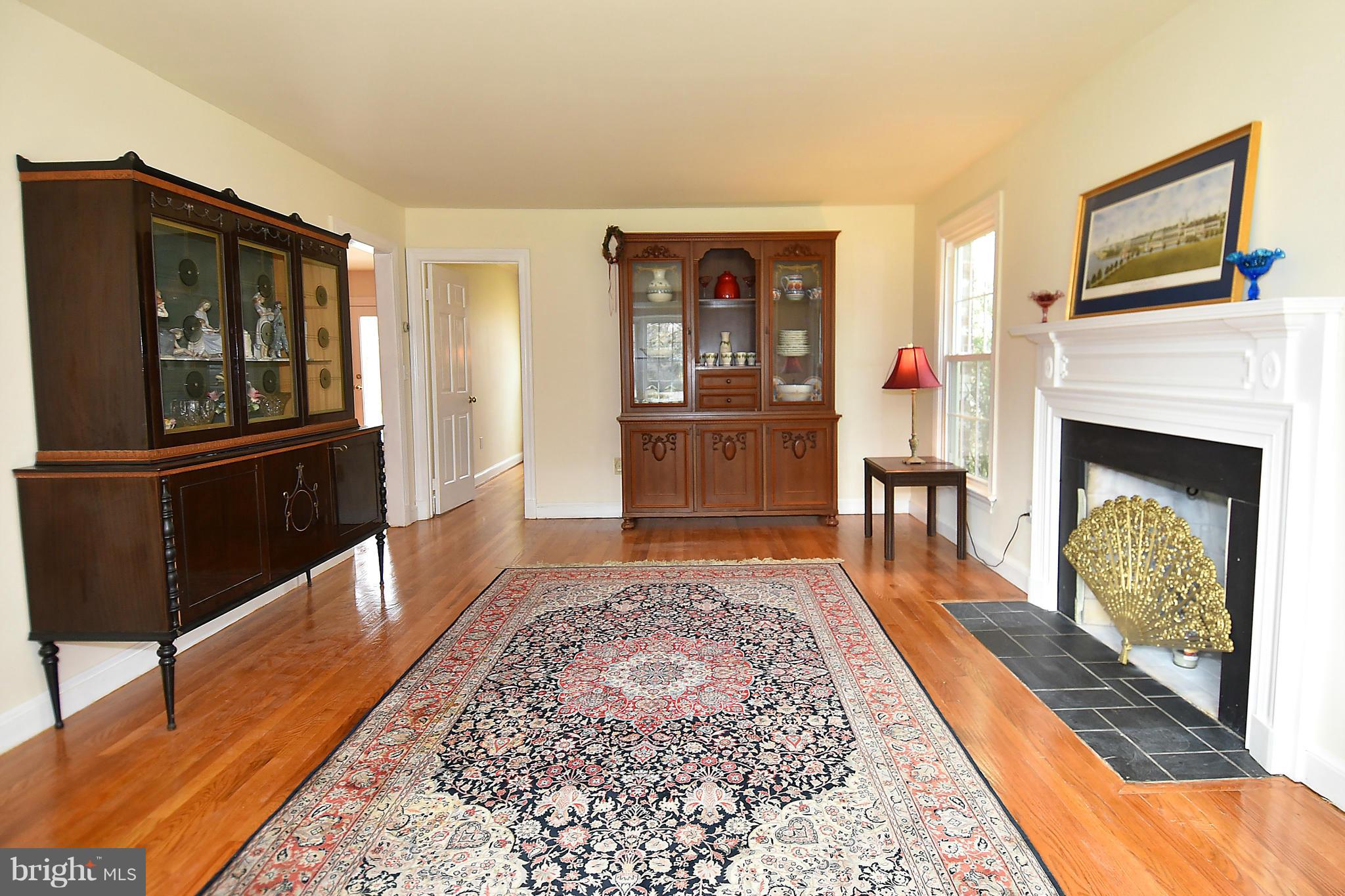 17939 Pond Road Ashton, MD 20861 - Photo 6 of 29 a living room with furniture rug and fireplace