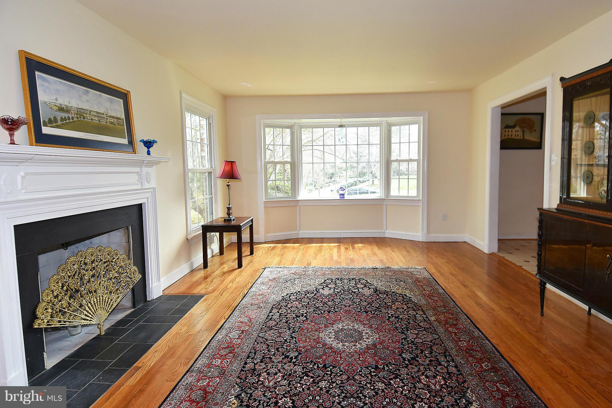 17939 Pond Road Ashton, MD 20861 - Photo 7 of 29 a living room with furniture rug and a fireplace