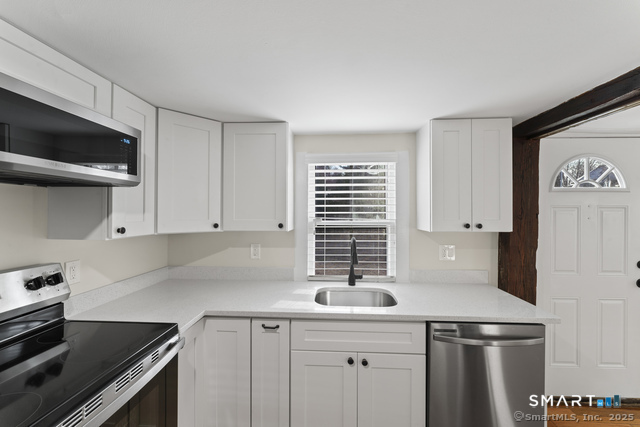 3 Riverside Road, Unit B Newtown, CT 06482 - Photo 6 of 20 a kitchen with stainless steel appliances a sink stove and cabinets