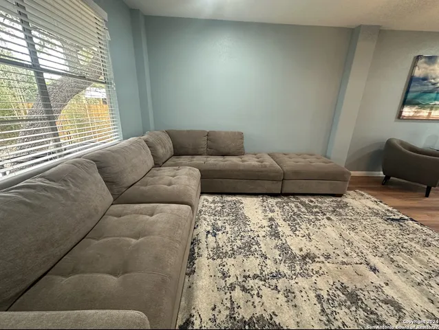 a living room with a couch and a large window
