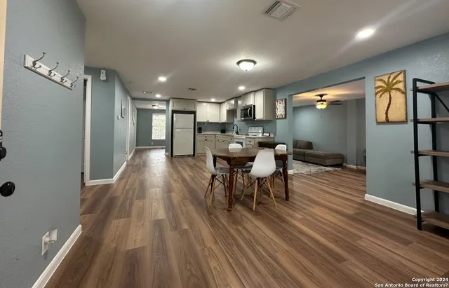 a view of a dining room with furniture window and wooden floor
