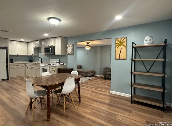 a view of a dining room with furniture and wooden floor