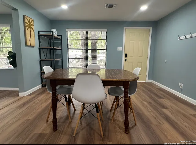 a view of a dining room with furniture and window