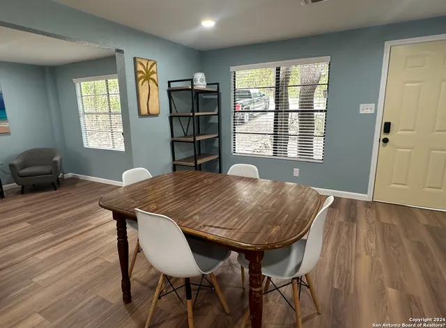 a view of a dining room with furniture and window