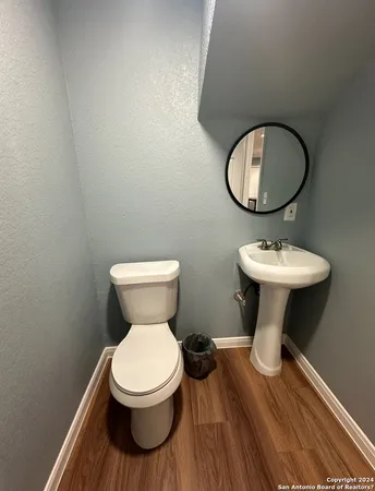 a bathroom with a toilet sink and mirror