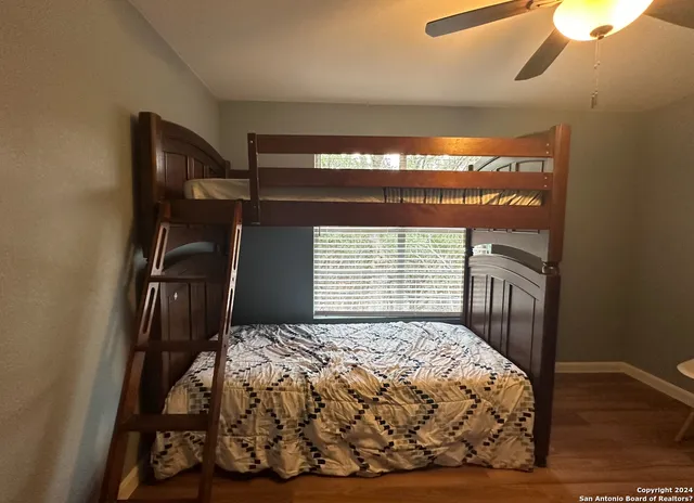 a bedroom with a bed and a mirror