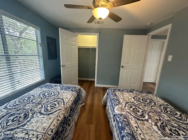 a bedroom with double bed and a chandelier