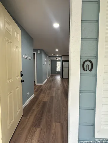 a view of a hallway with wooden floor
