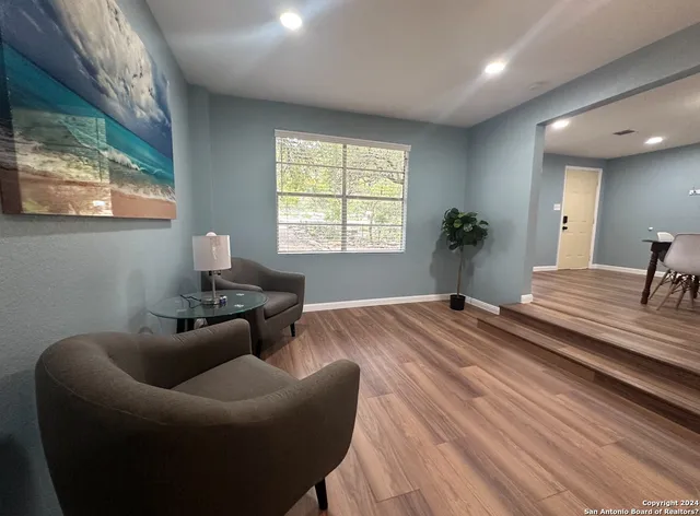 a living room with furniture and a large window