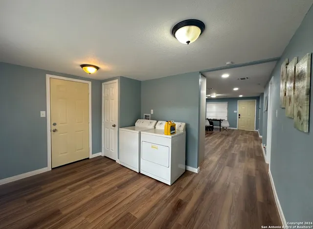 a view of storage and utility room with wooden floor