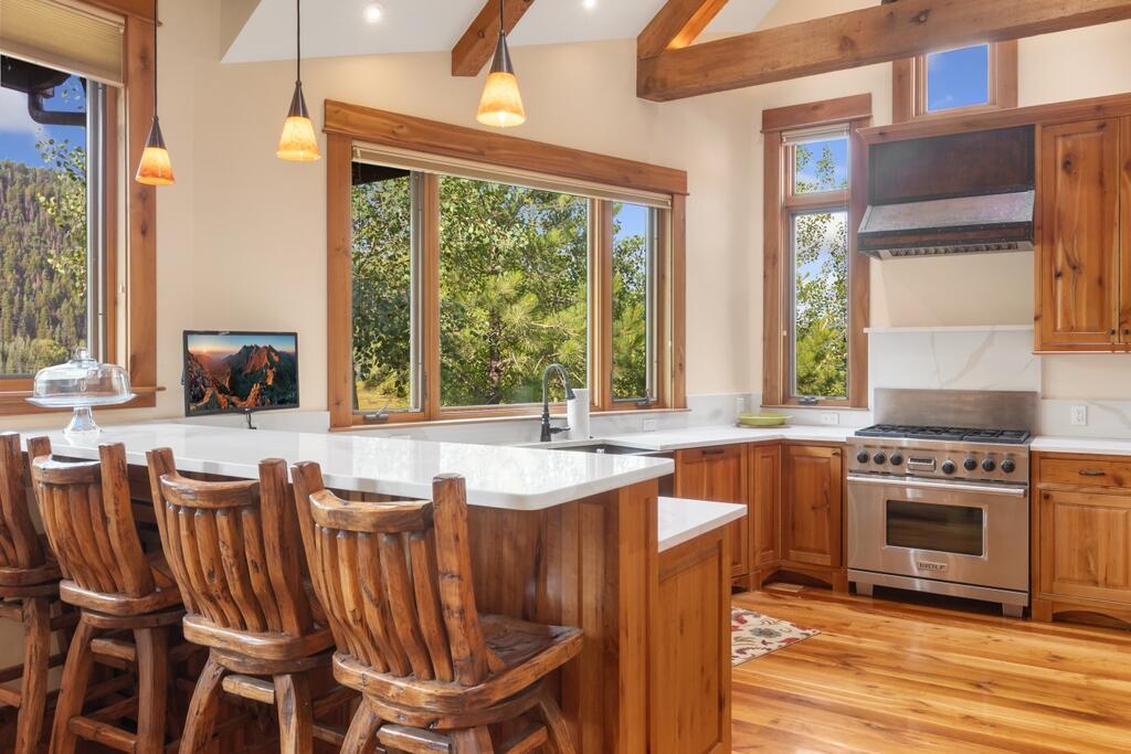 210 South Sunset Ridge Drive Telluride, CO 81435 - Photo 5 of 18 a kitchen with a table chairs sink and cabinets