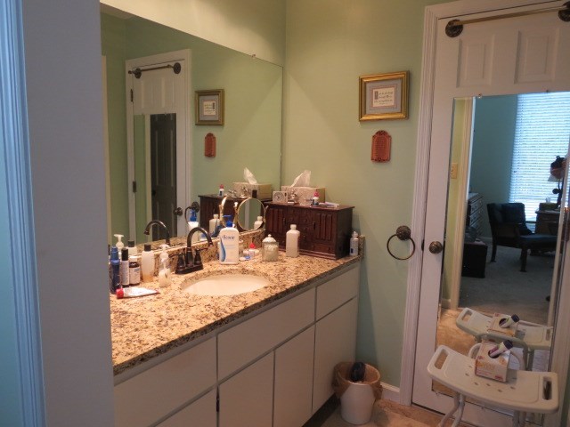 6974 Columbus Road Lizella, GA 31052 - Photo 11 of 19 a bathroom with a granite countertop sink and a mirror