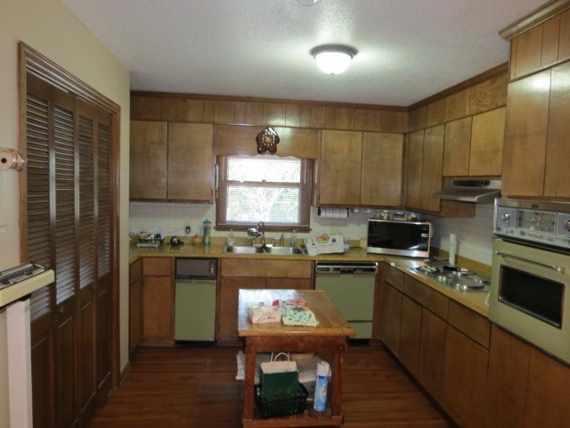 6974 Columbus Road Lizella, GA 31052 - Photo 8 of 19 a kitchen with kitchen island granite countertop a sink cabinets stainless steel appliances and a window