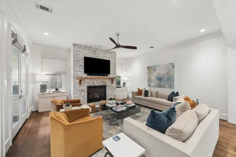 a living room with furniture a fireplace and a flat screen tv