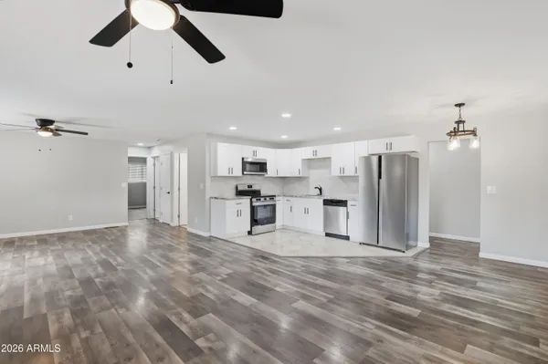 a view of a kitchen with stainless steel appliances refrigerator stove and kitchen island