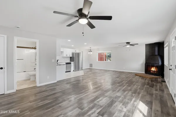 a view of an empty room and kitchen view