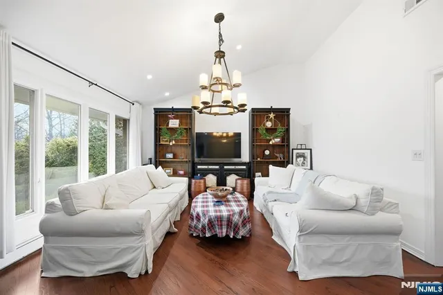 a living room with furniture and a chandelier