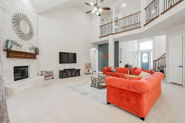 a living room with furniture kitchen view and a large window