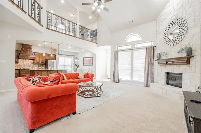 a living room with furniture fireplace and a chandelier