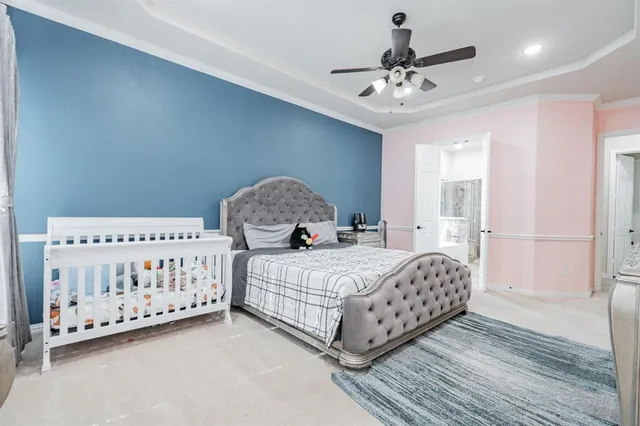 a bedroom with a bed and a dresser in it