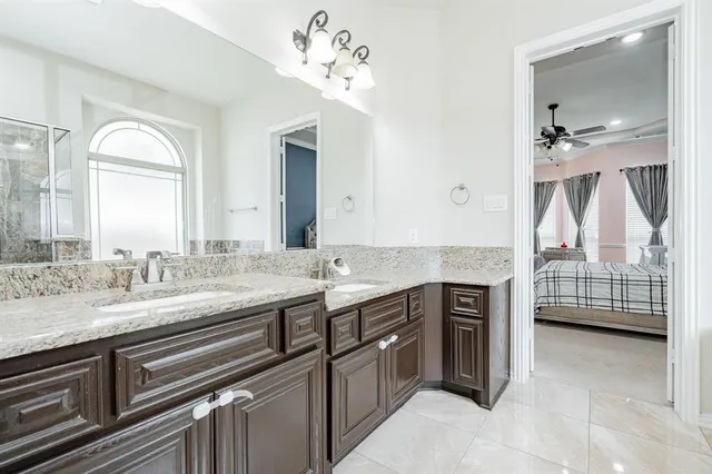 a bathroom with a tub mirror and window