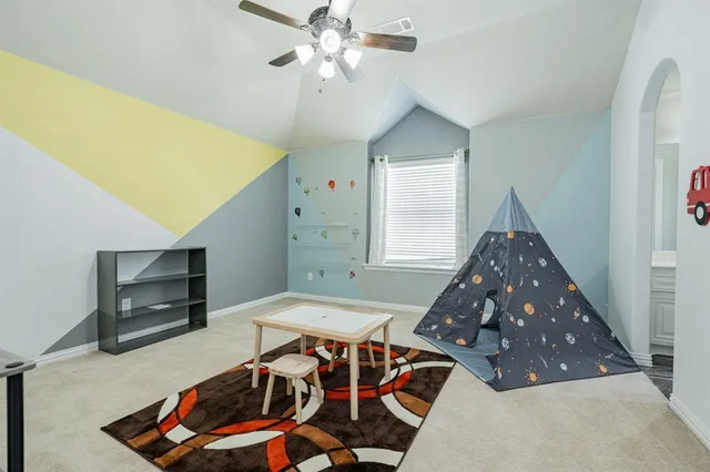 a bedroom with furniture and a chandelier