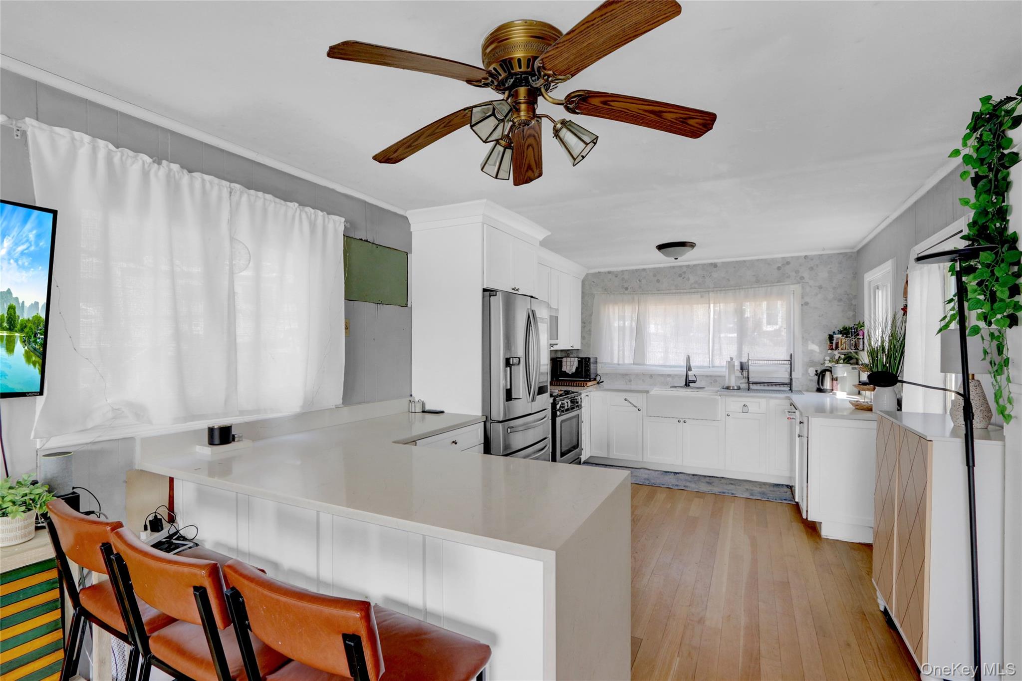 243 Lakeside Trail Ridge, NY 11961 - Photo 12 of 38 a kitchen with white cabinets and window